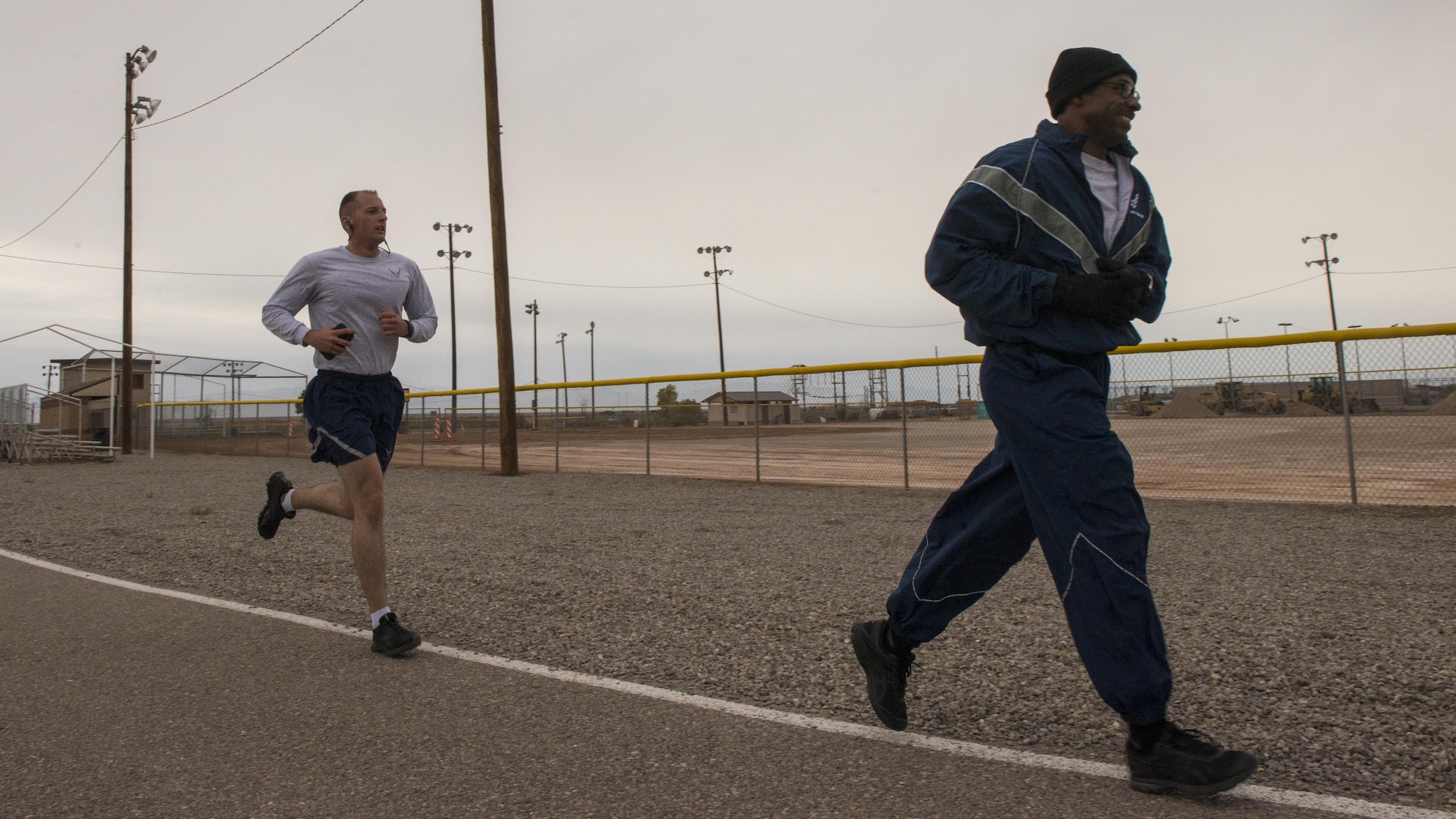 Two Airmen round a corner while racing in the 49th Force Support Squadron’s annual Turkey Trot on Nov. 21, 2016 at Holloman Air Force Base, N.M. Participants raced against the clock to compete for a variety of prizes, ranging from a frozen turkey to a $25 gift card. (U.S. Air Force photo by Airman 1st Class Alexis P. Docherty) 