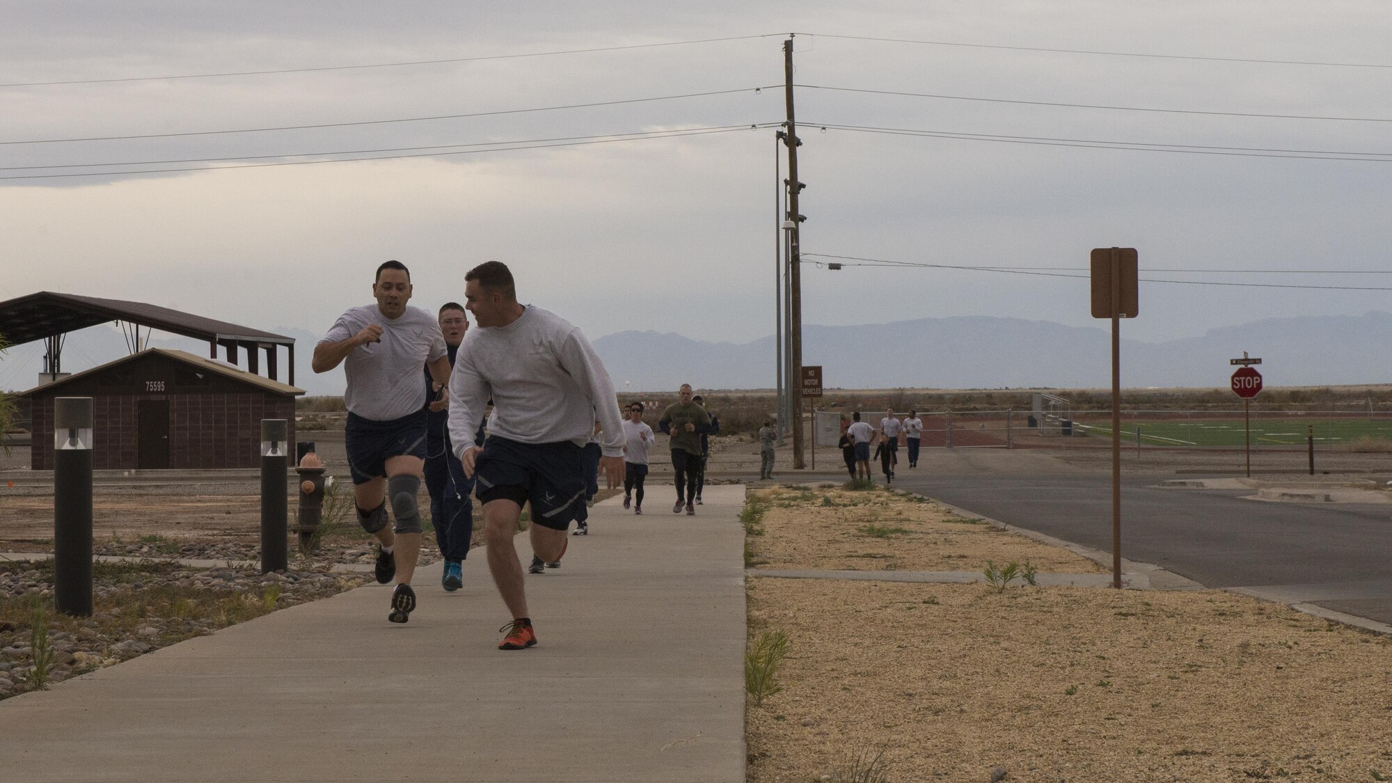 Participants race to the finish line during the 49th Force Support Squadron’s annual Turkey Trot on Nov. 21, 2016 at Holloman Air Force Base, N.M. The first, second, and third place winners were Thomas, Keonte, with the 49th Civil Engineer Squadron, and Michael, with the 54th Aircraft Maintenance Squadron, respectively. (U.S. Air Force photo by Airman 1st Class Alexis P. Docherty. Last names are being withheld due to operational requirements.) 