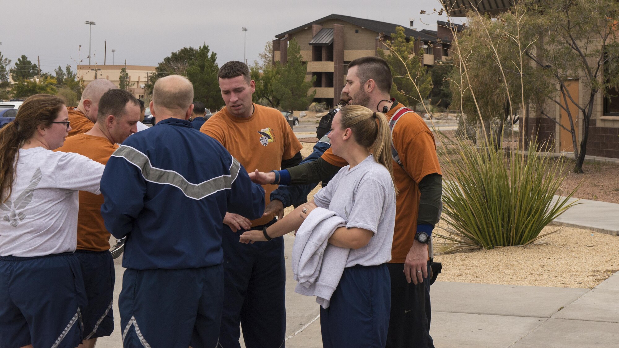 A group of participants gather for a group handshake after the 49th Force Support Squadron’s annual Turkey Trot on Nov. 21, 2016 at Holloman Air Force Base, N.M. The Turkey Trot is a 5 km run across the base trail. (U.S. Air Force photo by Airmen 1st Class Alexis P. Docherty) 

