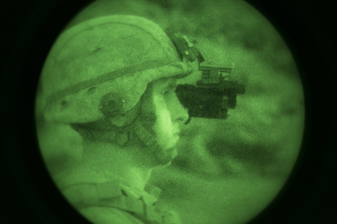 A tactical controller with Tactical Training Exercise Control Group observes as Marines with 1st Battalion, 7th Marine Regiment, fire at a target at Range 400 aboard Marine Corps Air Ground Combat Center, Twentynine Palms, Calif., during 1/7’s night-time combined arms live-fire exercise Nov. 16, 2016. (Official Marine Corps photo by Cpl. Julio McGraw/Released)