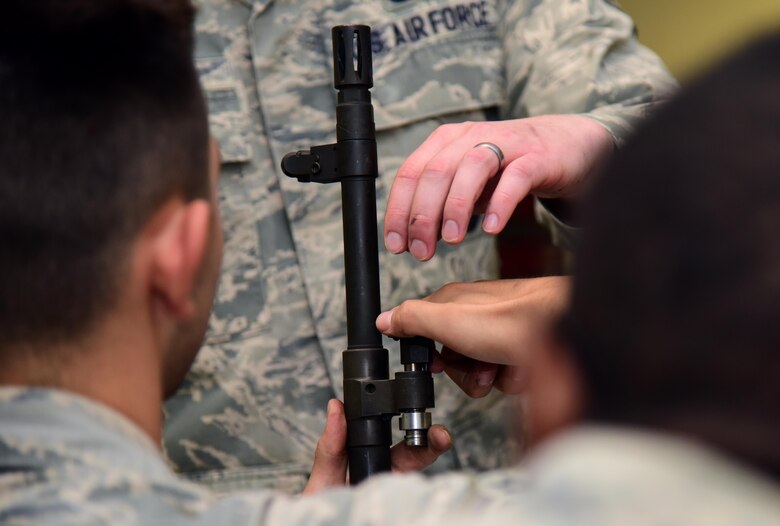 Airmen from the 509th Security Forces Squadron function check a gas regulator on an M240B light machine gun at Whiteman Air Force Base, Mo., Nov. 9, 2016. During classroom instruction, Airmen are familiarized with the weapon that they will be firing as well as basic weapon safety.