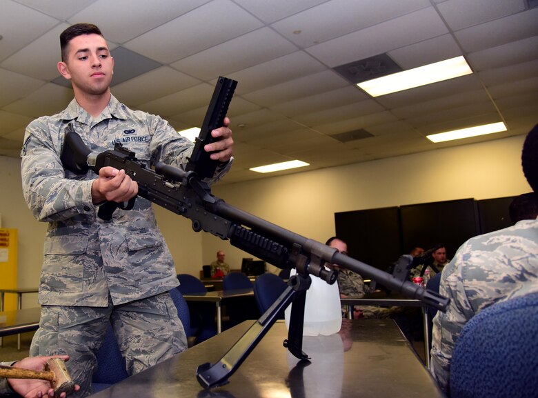 U.S. Air Force Airman 1st Class Johnathan Gomez, a 509th Security Force Squadron security response team member, ensures an M240B light machine gun is clear before disassembly at Whiteman Air Force Base, Mo., Nov. 9, 2016. During qualification training, Airmen are taught proper safety and function checks before firing a weapon at the range.