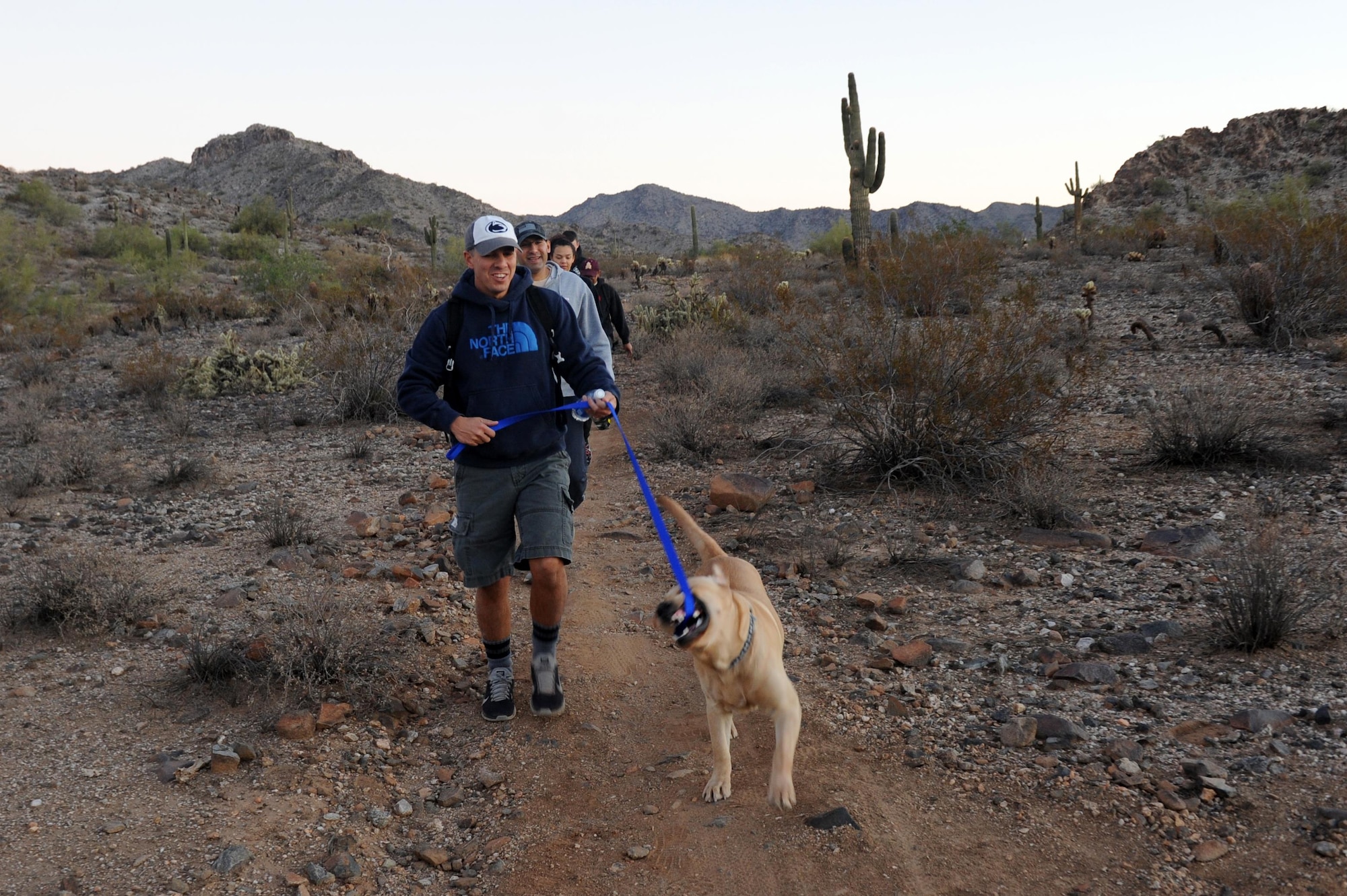 Senior Master Sgt. Mark James, 56th Maintenance Group maintenance operations flight training flight superintendent, hikes with his dog Nov. 18, 2016 at the White Tank Mountains in Surprise, Ariz. The 56th MXG held a monthly hike to build morale and leadership.(U.S. Air Force photo by Airman 1st Class Pedro Mota)