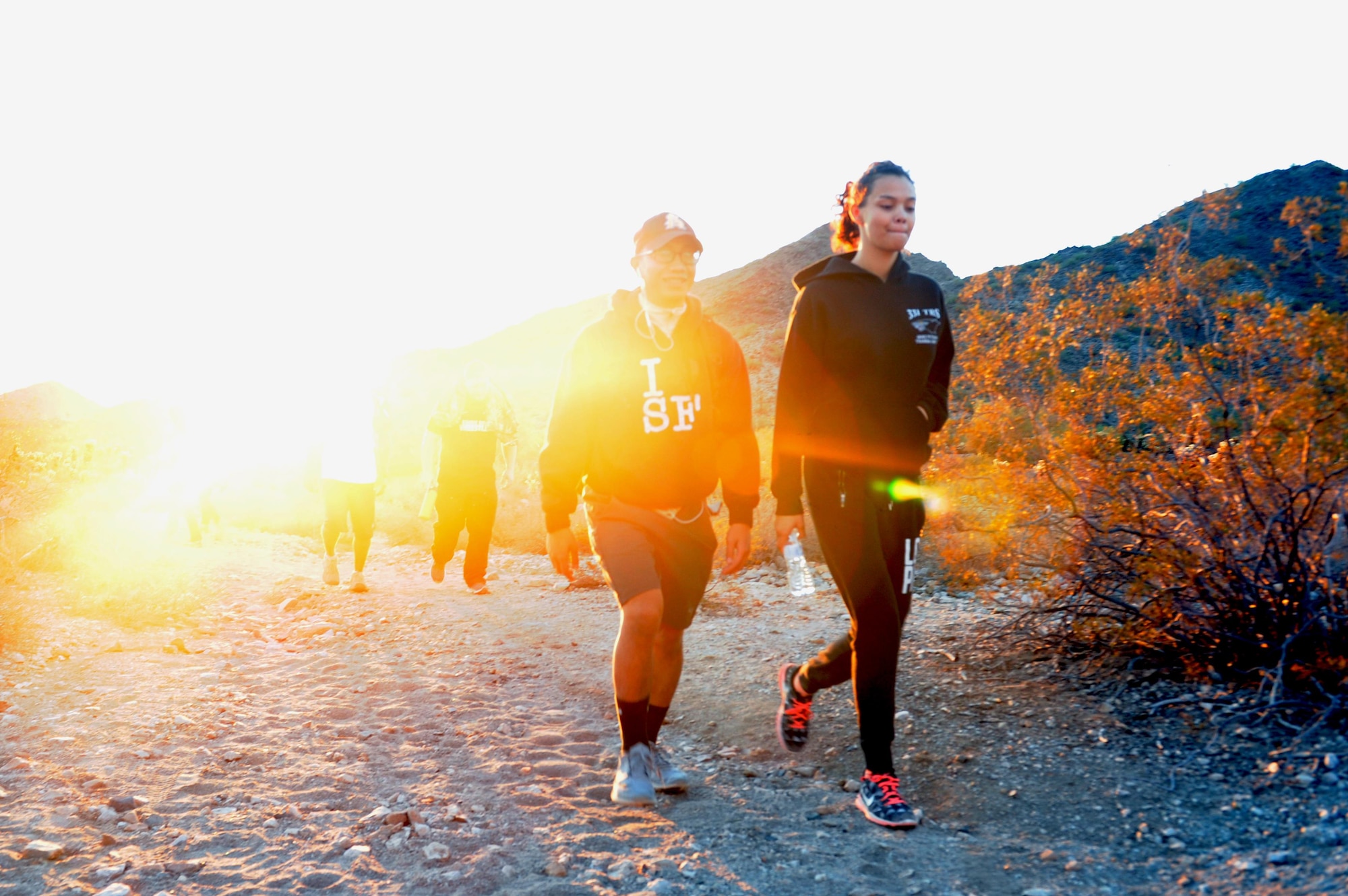 Airman 1st Class Jeremy Ceralde, 56th Maintenance Group maintenance operations scheduler, and Airman Jasmine Dorsey, 56th MXG maintenance operations scheduler, hike the Verrado trailhead Nov. 18, 2016 at the White Tank Mountains in Surprise, Ariz. Maintenance operations Airmen are hiking monthly to promote morale. (U.S. Air Force photo by Airman 1st Class Pedro Mota)