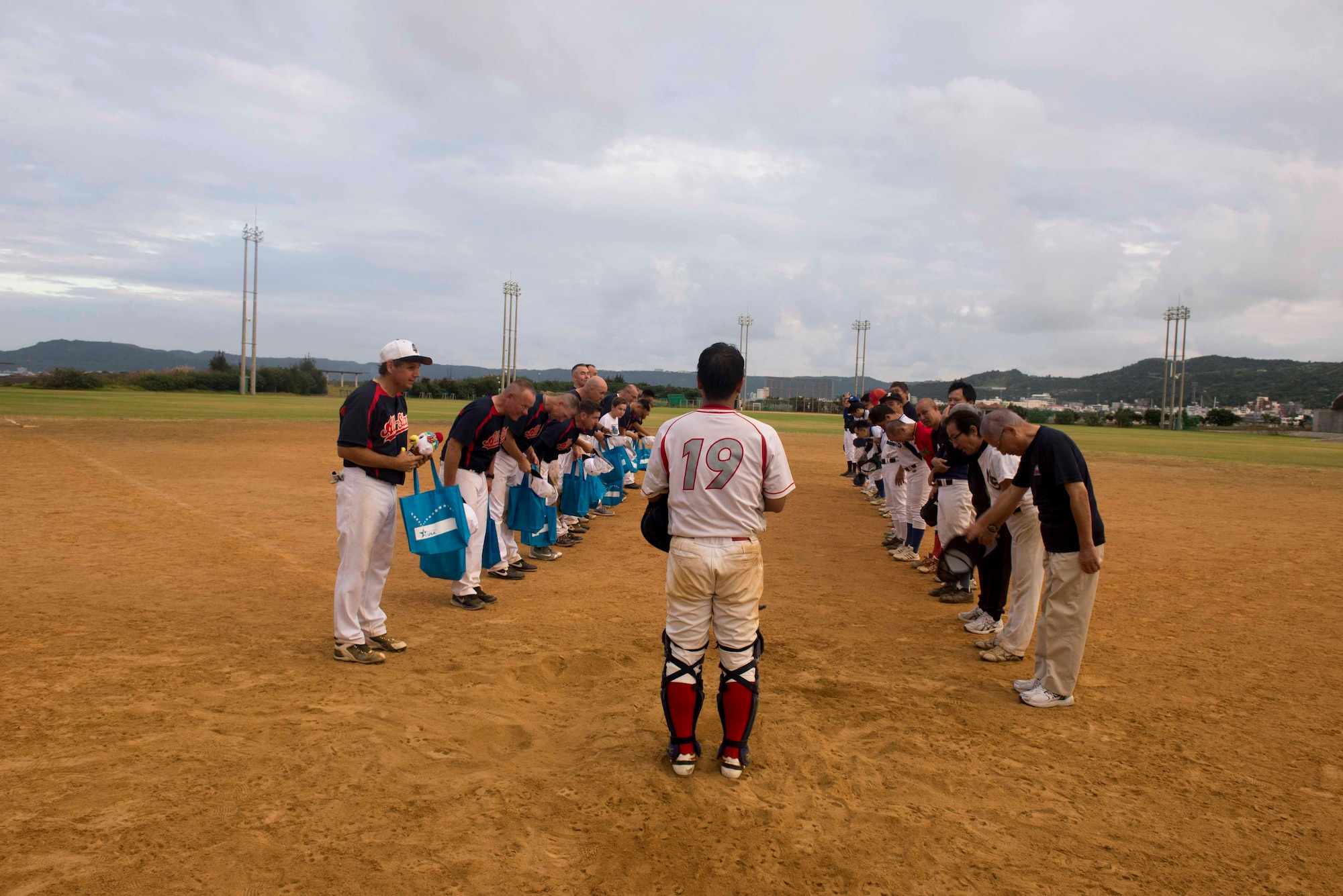 Members of the U.S. Consulate Allstars and Okinawa Prefectural Government Baseball Teams bow to each other after a baseball game Nov. 19, 2016, at a baseball field in  Naha, Japan. The Allstars play games against teams on Okinawa to make friends and foster partnerships in the local community. (U.S. Air Force photo by Senior Airman Omari Bernard/Released)xxx