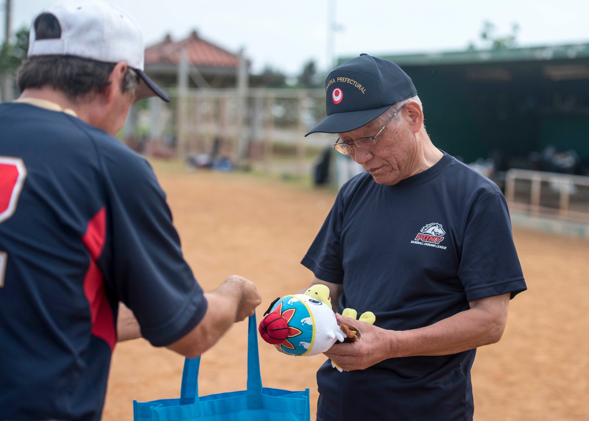 Isho Urasaki, Okinawa Prefectural Government vice-governor, receives a gift from Joel Ehrendreich, U.S. Consul general, Naha, after a baseball game Nov. 19, 2016, in Naha, Japan. The main focus of the baseball game was to build relationships with the Okinawan Prefectural Government and the people of Okinawa. (U.S. Air Force photo by Senior Airman Omari Bernard/Released)