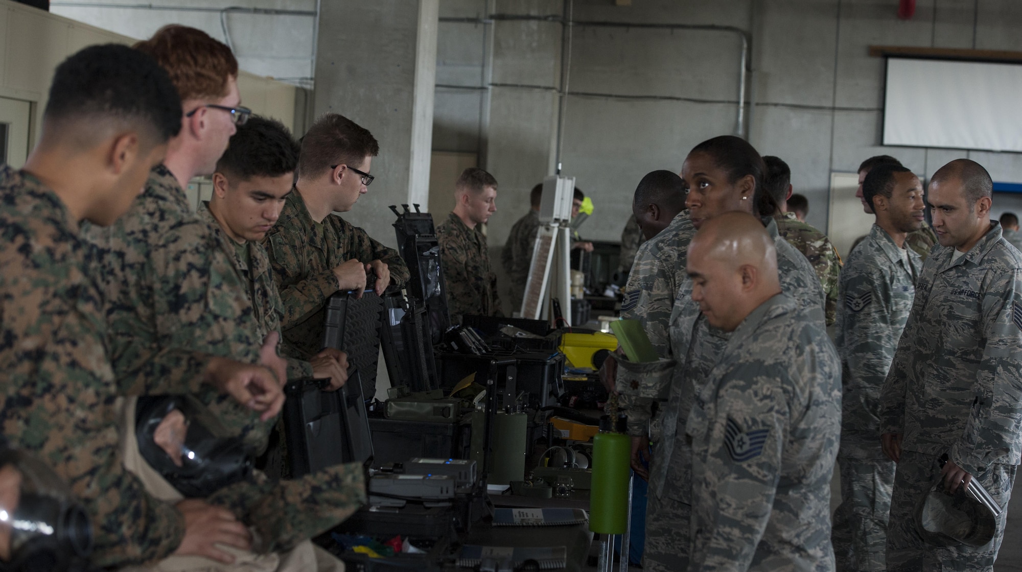 U.S. Marine Corps and Air Force service members look at different Chemical, Biological, Radiological and Nuclear equipment during the CBRN Exposition Nov. 17, 2016, at Kadena Air Base, Japan. Service members from all branches of service compare one another’s equipment during the event. (U.S. Air Force photo by Senior Airman Lynette M. Rolen/Released)