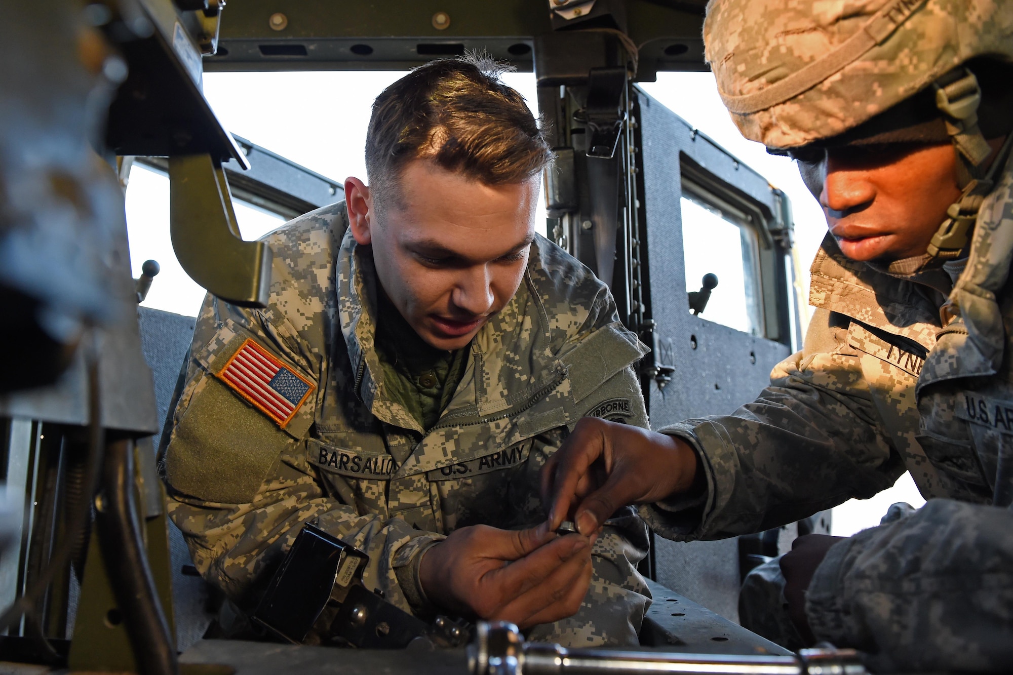 Pfc. Angelo Barsallo, and Pvt. Rushawn Tyne, assistant gunners with the 2nd Battalion, 377th Parachute Field Artillery Regiment, 4th Infantry Brigade Combat Team (Airborne), 25th Infantry Division, U.S. Army Alaska, secure the battery of a Humvee at the 773d Logistics Readiness Squadron Movement Control Center at Joint Base Elmendorf-Richardson, Alaska, Nov. 15, 2016. Cargo processed through the MCC will be shipped to the National Training Center at Fort Irwin, Calif. 