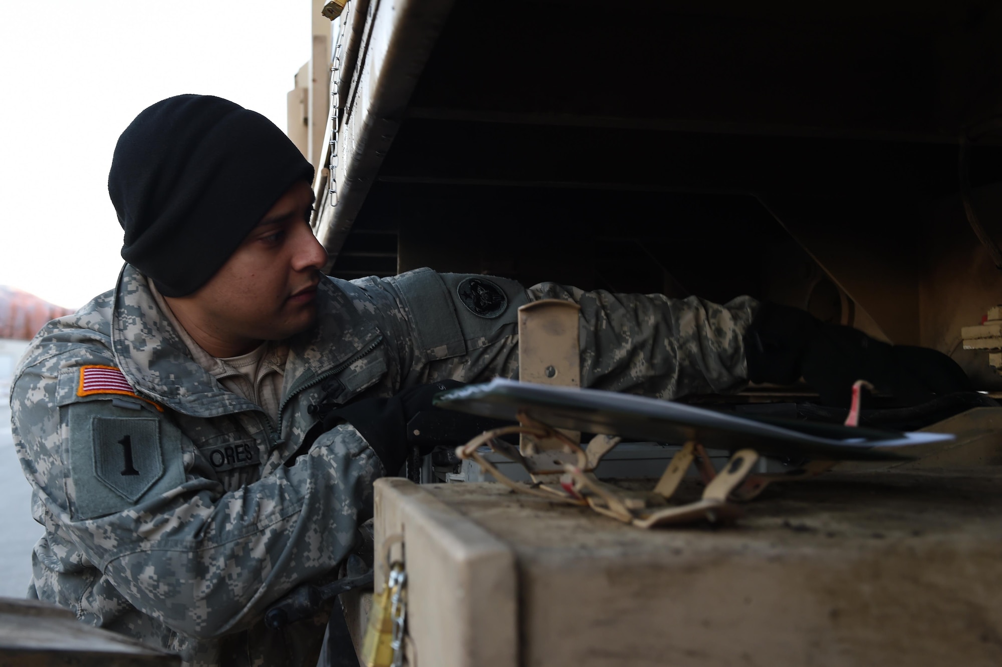 Army Staff Sgt. Rudy Flores, 98th Support Maintenance Company, 17th Combat Sustainment Support Battalion, a U.S. Army Alaska Headquarters platoon sergeant, checks the batteries on an Heavy Expanded Mobility Tactical Truck A4 Recovery Truck at the 773d Logistics Readiness Squadron Movement Control Center at Joint Base Elmendorf-Richardson, Alaska, Nov. 15, 2016. Cargo processed through the MCC will be shipped to the National Training Center at Fort Irwin, Calif. 