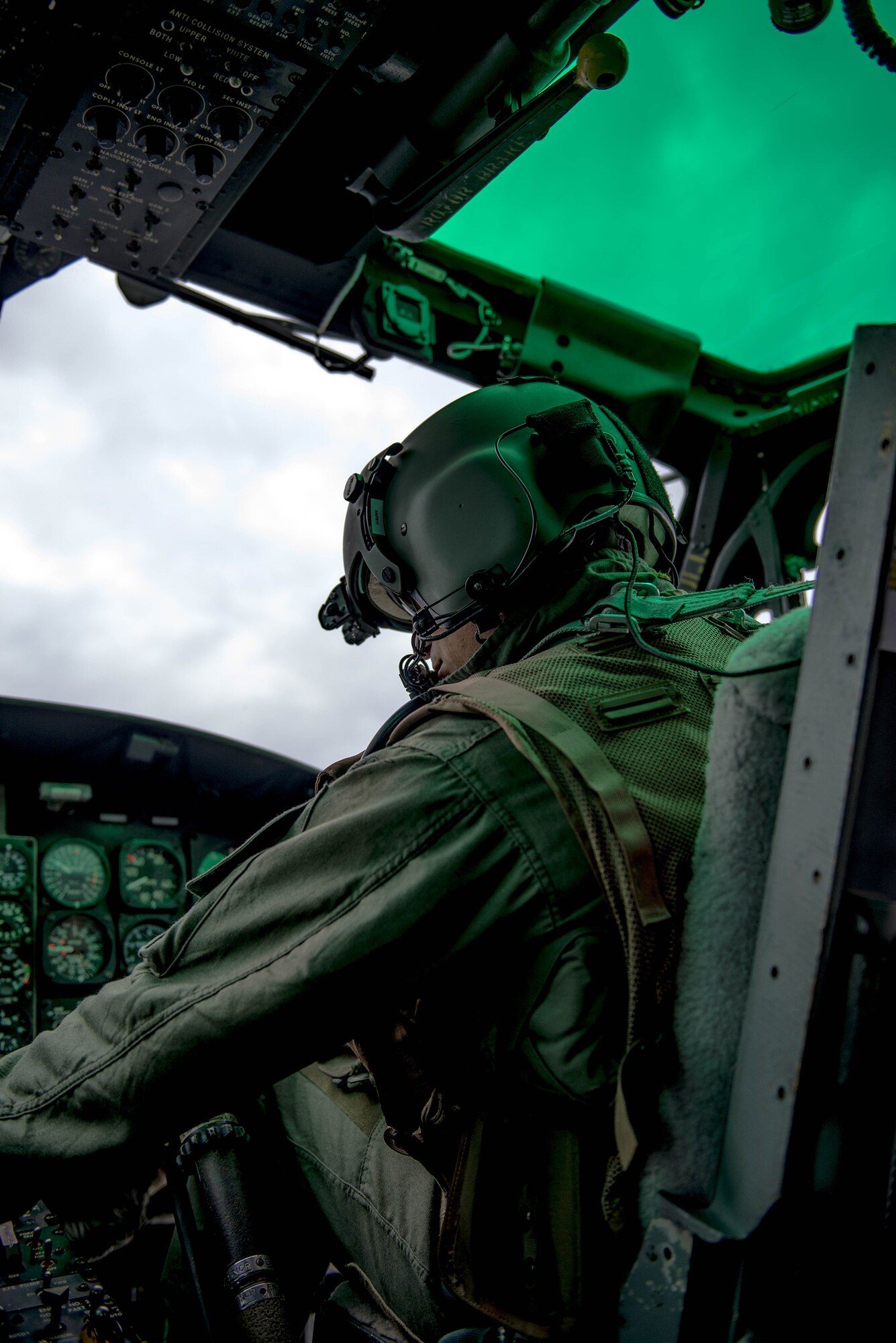 Capt. Vicente Vasquez, 459th Airlift Squadron UH-1N Iroquois instructor pilot, checks instrument over Japan, Nov 21, 2016, during a Tokyo Metropolitan Government Comprehensive Disaster Management Drill. Yokota’s 459 AS worked with the Japan Self-Defense Forces, U.S. Army and U.S. Navy on an exercise delivering simulated humanitarian aid to Oshima island, Japan, after a volcanic eruption. (U.S. Air Force  photo by Senior Airman Justin Carnahan/Released)
