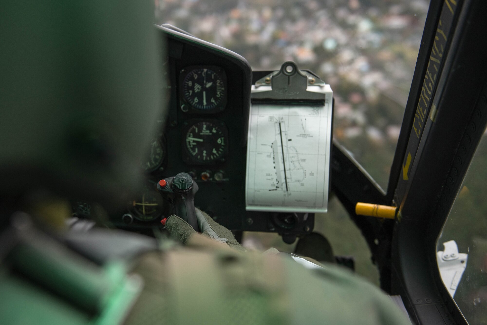 Captain Vicente Vasquez, 459th Airlift Squadron UH-1N Iroquois instructor pilot,  flies over Japan, Nov 21, 2016. The 459 AS, Japan Self-Defense Forces, U.S. Army and U.S. Navy practiced delivering simulated relief supplies to Oshima Island. (U.S. Air Force  photo by Senior Airman Justin Carnahan/Released)                                                                                                                                