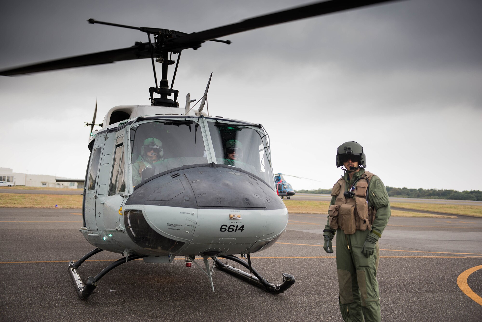 Crewmembers of a 459th Airlift Squadron UH-1N Iroquois stop off at Oshima Airport to drop off supplies during a Tokyo Metropolitan Government Comprehensive Disaster Management Drill, Nov. 21, 2016. The 459 AS, Japan Self-Defense Forces, U.S. Army and U.S. Navy practiced delivering simulated relief supplies to Oshima Island, Japan. (U.S. Air Force  photo by Senior Airman Justin Carnahan/Released)