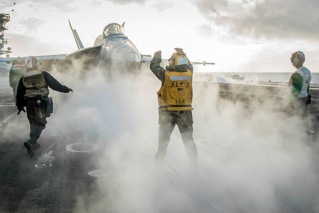 Sailors direct the pilot of an F/A-18E Super Hornet on the flight deck of the USS Carl Vinson in the Pacific Ocean, Nov. 21, 2016. The Vinson recently completed unit training exercises in preparation for an upcoming deployment. Navy photo by Petty Officer 3rd Class Sean M. Castellano