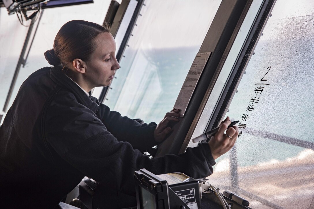 Navy Seaman Rachel Stempko makes notes as the forward spotter in the primary flight control room of the USS Dwight D. Eisenhower in the Persian Gulf, Nov. 20, 2016. The Ike is supporting Operation Inherent Resolve. Navy photo by Seaman Joshua Murray