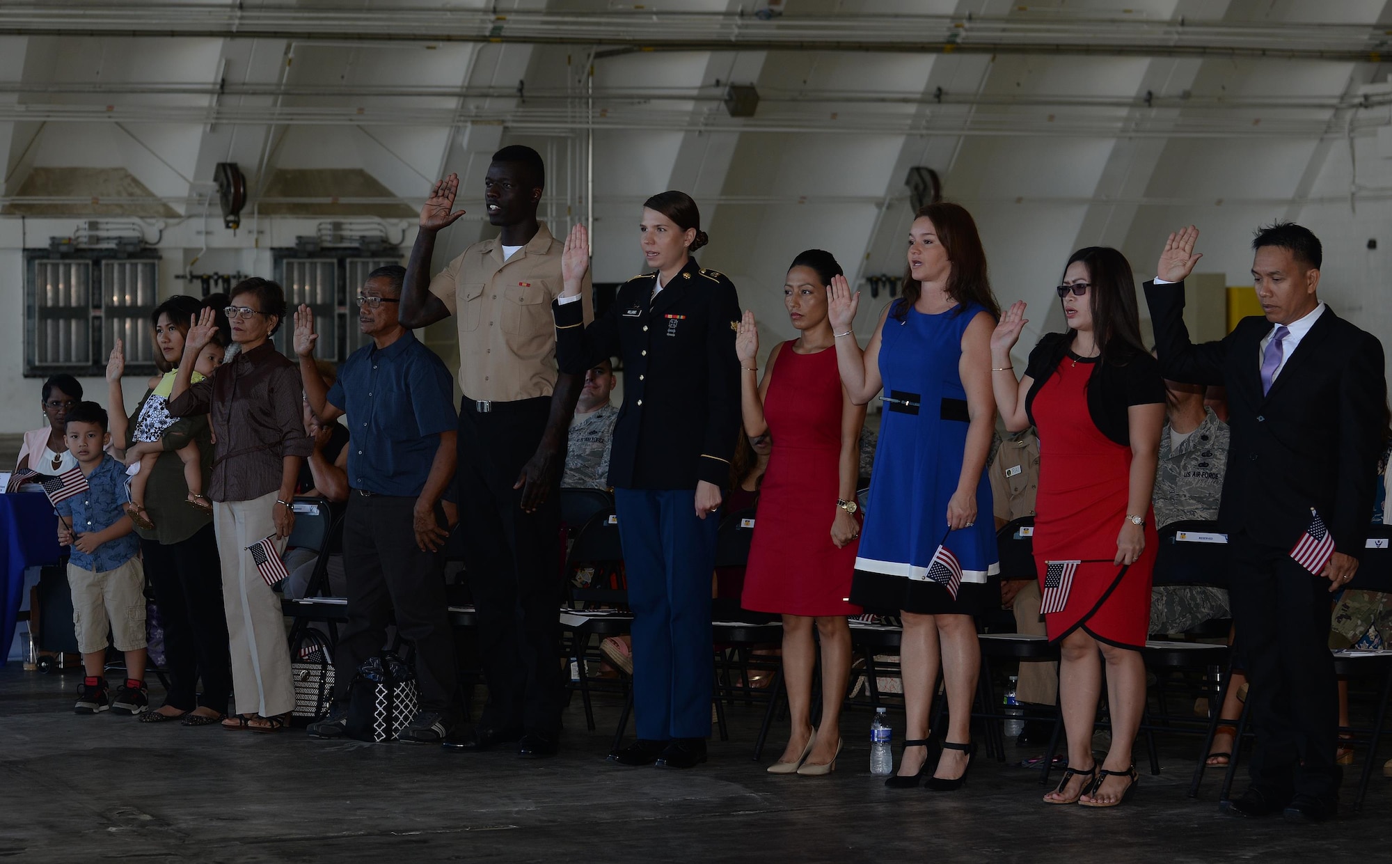 Prospective U.S. citizens take the Oath of Allegiance during a naturalization ceremony Nov. 23, 2016, on Andersen Air Force Base, Guam. The oath is recited during the ceremony, signifying an individual pledging their allegiance to the United States of America. (U.S. Air Force photo/Staff Sgt. Benjamin Gonsier)