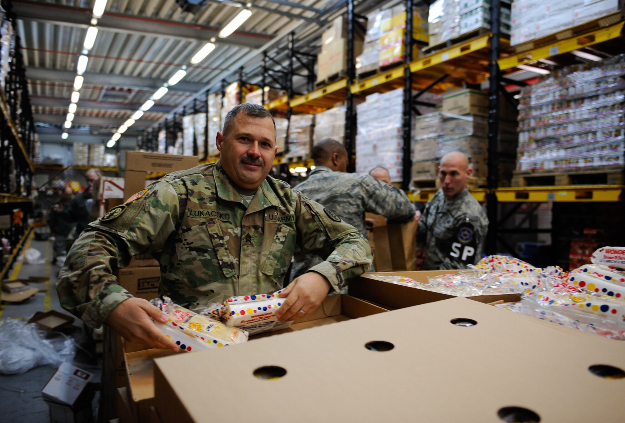 U.S. Army Sgt. 1st Class Jonathan Lukacsko, Public Health Activity-Rheinland Pfalz operations NCO, volunteers at the Thanks for Thanksgiving event at Vogelweh Air Base, Germany, Nov. 19, 2016. This year is the first time in 17 years the Army and the Air Force have collaborated for Thanks for Thanksgiving, creating more than 660 meals for military families.  (U.S. Air Force photo by Airman 1st Class Savannah L. Waters)