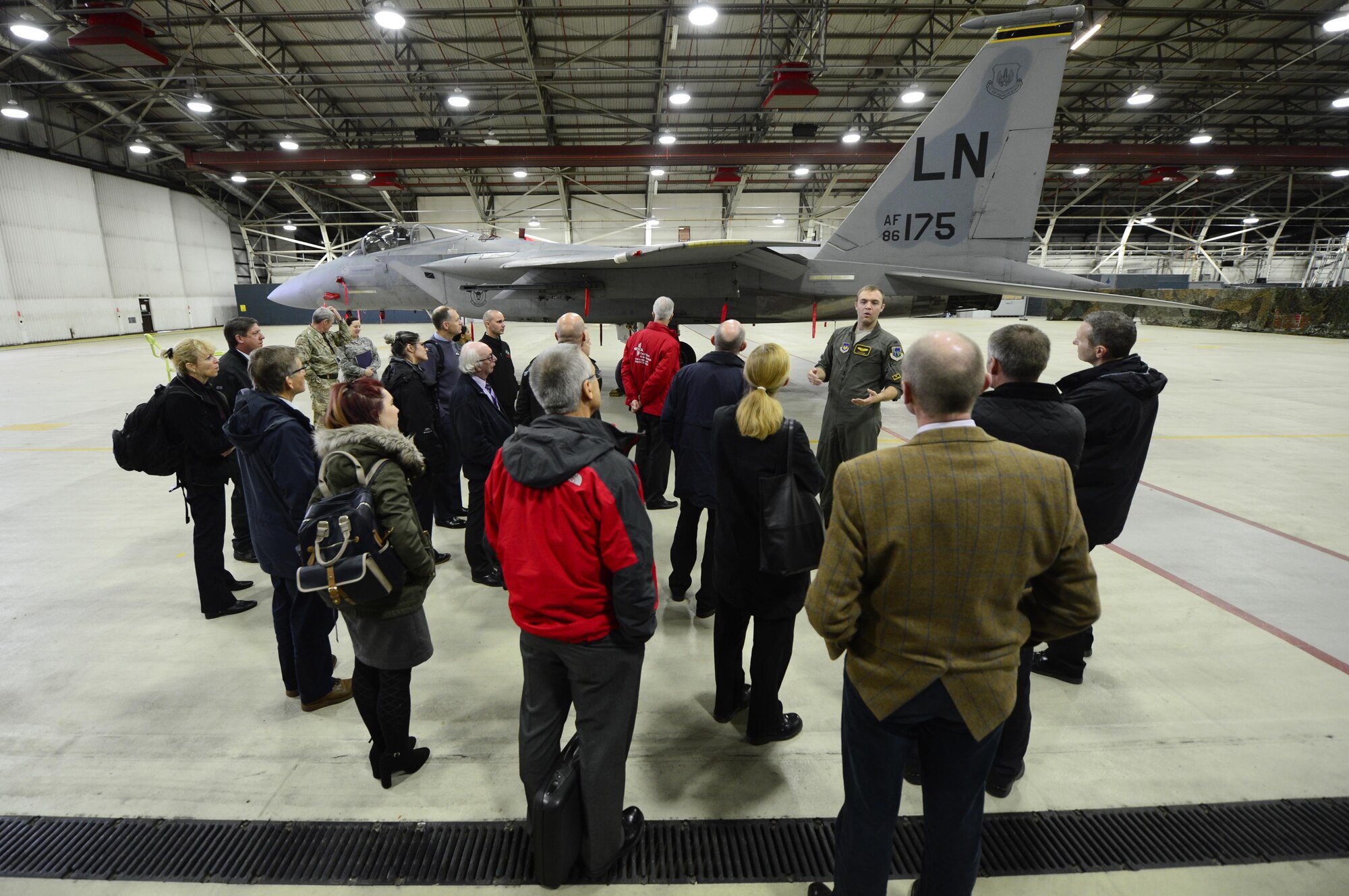 A 493rd Fighter Squadron pilot tells U.K. visitors about F-15C Eagle aircraft at Royal Air Force Lakenheath, England, Nov. 17. U.K. first responders visited the 48th Fighter Wing to discuss joint emergency response efforts. (U.S. Air Force photo/ Senior Airman Malcolm Mayfield)