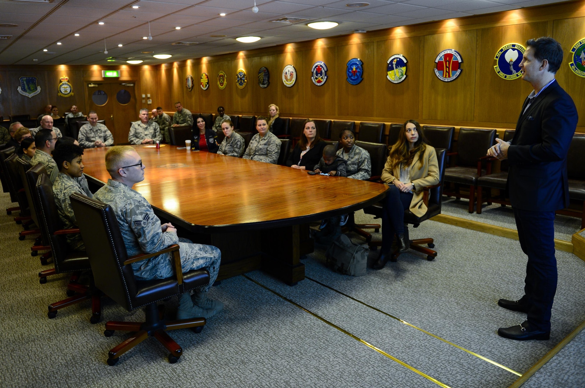 Tom Burkett, Troop Rewards director, presents free family vacations to 48th Fighter Wing Airmen, Nov. 21, at Royal Air Force Lakenheath, England. More than $50,000 worth of vacations were given to military families during Burkett’s two-week trip to Europe. (U.S. Air Force photo/Senior Airman Malcolm Mayfield)