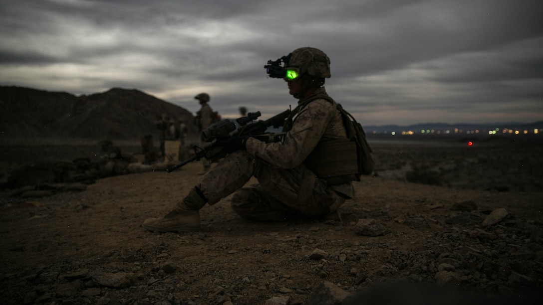 Cpl. Ryan Weston, squad leader, 1st Battalion, 7th Marine Regiment, looks down Range 400 at Marine Corps Air Ground Combat Center, Twentynine Palms, California, during the unit’s night-time combined arms live-fire exercise Nov. 16, 2016. 