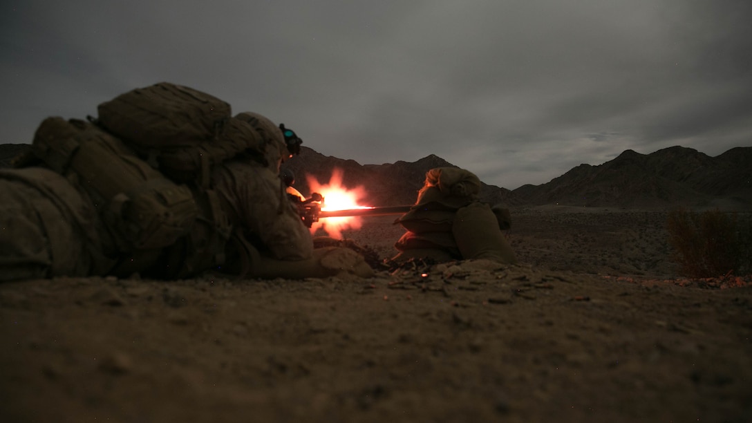 Lance Cpl. Zach Frankley and Pfc. Kervin Jean-Claude, machine gunners, 1st Battalion, 7th Marine Regiment, fire at a target at Range 400 at Marine Corps Air Ground Combat Center Twentynine Palms, California, during the unit’s night-time combined arms live-fire exercise Nov. 16, 2016. 