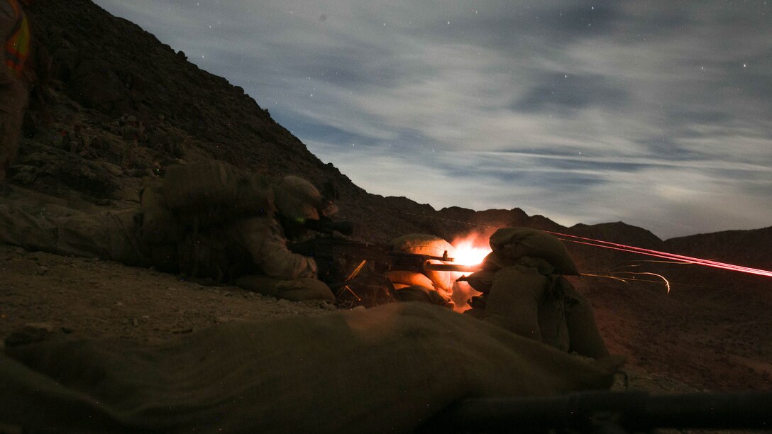 Machine gunners with 1st Battalion, 7th Marine Regiment, fire an M240B medium machine gun at a target at Range 400 at Marine Corps Air Ground Combat Center, Twentynine Palms, California, during the unit’s night-time combined arms live-fire exercise Nov. 16, 2016. 