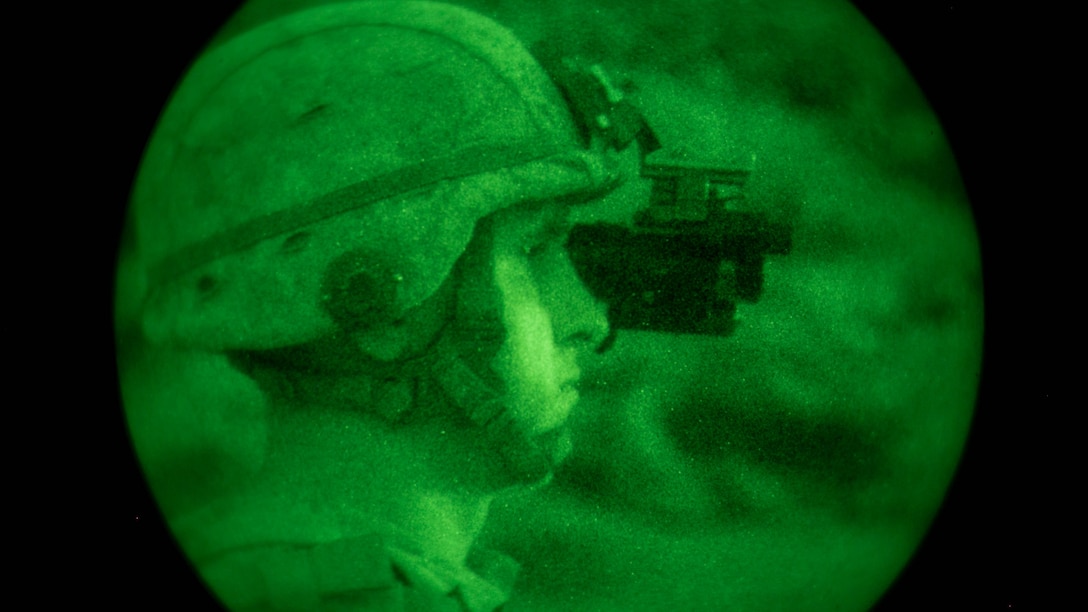 A tactical controller with Tactical Training Exercise Control Group observes as Marines with 1st Battalion, 7th Marine Regiment, fire at a target at Range 400 at Marine Corps Air Ground Combat Center, Twentynine Palms, California, during 1/7’s night-time combined arms live-fire exercise Nov. 16, 2016. 