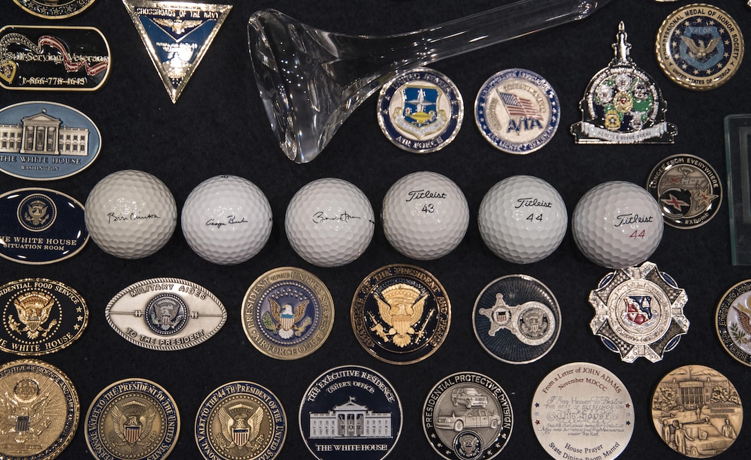 Golf balls used by Former Presidents Bill Clinton and George Bush, and President Barack Obama are displayed alongside challenge coins at Joint Base Andrews, Md., Nov. 17, 2016. The first president to play at The Courses at Andrews was former President Gerald R. Ford in 1974. (U.S. Air Force photo by Senior Airman Jordyn Fetter)