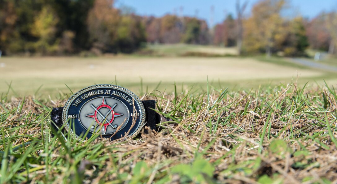 A challenge coin from The Courses at Andrews rests on the golf course at Joint Base Andrews, Md., Nov. 17, 2016. The golf course sees approximately 70,000 rounds of golf a year, played by individuals ranging from 11th Wing Airmen to the U.S. president (U.S. Air Force photo by Senior Airman Jordyn Fetter)