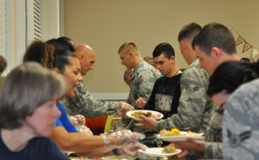 Enlisted Airmen who reside in the dorms enjoy a home-cooked meal Nov. 17, 2016, at the chapel annex on Columbus Air Force Base, Mississippi. Base private organizations banded together with Team BLAZE leadership to donate, prepare and serve a Thanksgiving meal to Airmen who may not get to return home for the holidays. (U.S. Air Force photo by Richard Johnson)