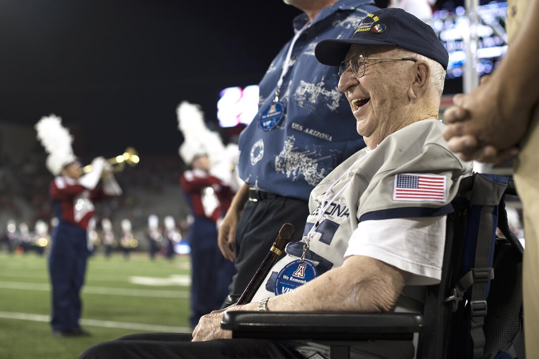 Lauren Bruner, one of the last surviving crew members of the battleship USS Arizona, smiles during a performance by the Pride of Arizona marching and pep band at Arizona Stadium in Tucson, Sept. 17, 2016. Bruner was honored throughout the Arizona Wildcats versus Hawaii Rainbow Warriors football game commemorating the 75th anniversary of the Dec. 7, 1941 Japanese attacks on Pearl Harbor, Hawaii. Air Force photo by Senior Airman Chris Drzazgowski