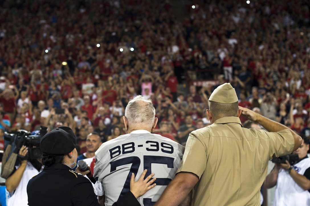 Lauren Bruner, one of the last surviving crew members of the battleship USS Arizona, stands and faces a crowd during a performance of the National Anthem at Arizona Stadium in Tucson, Sept. 17, 2016. Bruner was honored throughout the Arizona Wildcats versus Hawaii Rainbow Warriors football game commemorating the 75th anniversary of the Dec. 7, 1941 Japanese attacks on Pearl Harbor, Hawaii. Air Force photo by Senior Airman Chris Drzazgowski