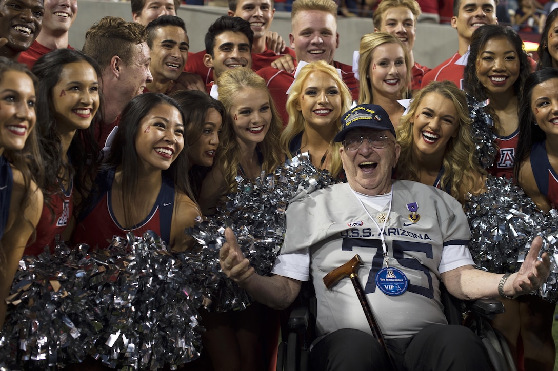 Lauren Bruner, survivor of the Dec. 7, 1941 attacks on Pearl Harbor, Hawaii, poses for a photo with the University of Arizona cheerleaders at Arizona Stadium in Tucson, Sept. 17, 2016. Bruner was honored throughout the Arizona Wildcats versus Hawaii Rainbow Warriors football game commemorating the 75th anniversary of the Japanese attacks on Pearl Harbor. Air Force photo by Senior Airman Chris Drzazgowski