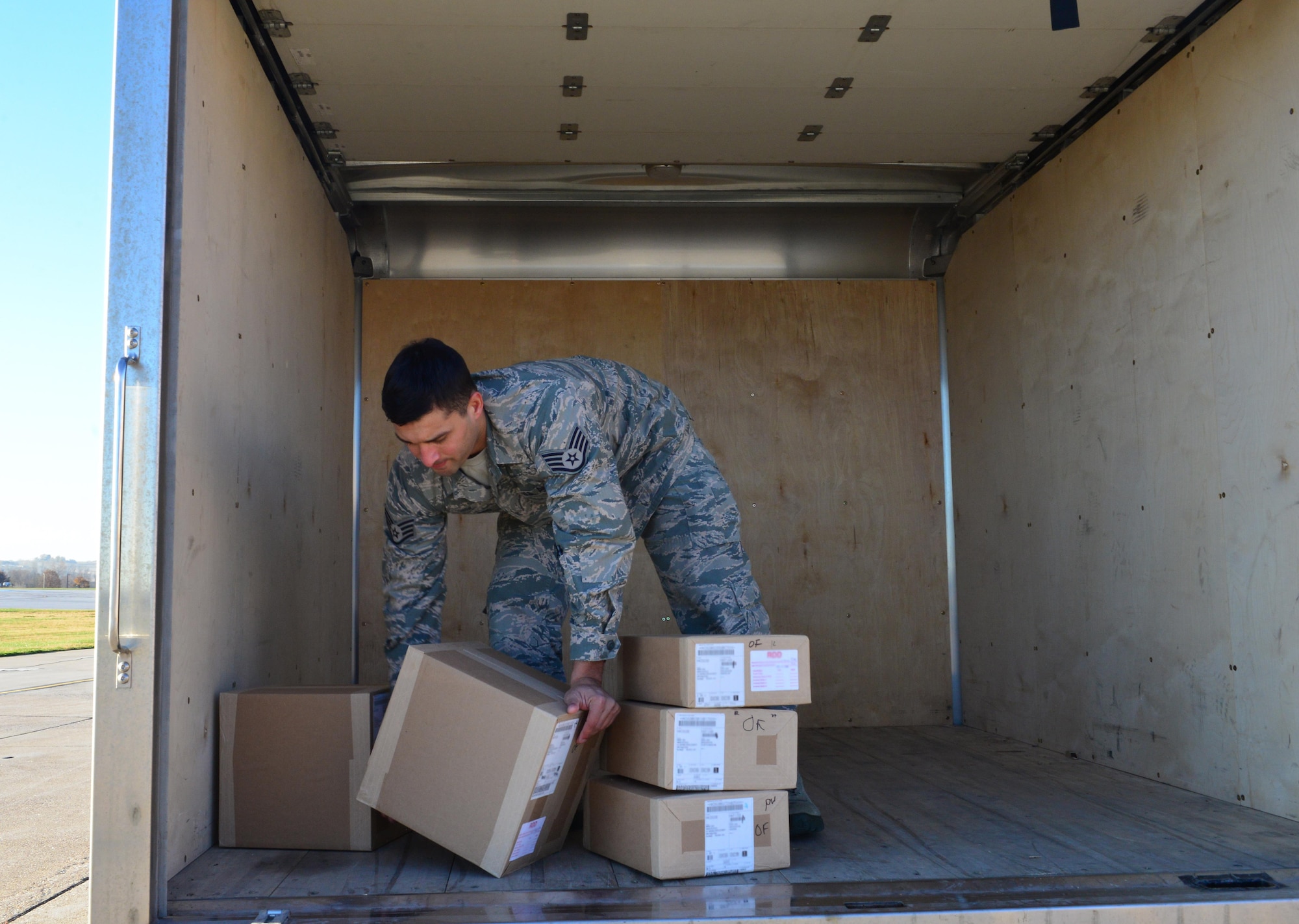 Staff Sgt. Ruben Lozano, a defense courier with Defense Courier Station Offutt, unloads boxes containing sensitive equipment on the flight line at Offutt Air Force Base, Neb., Nov. 16, 2016. Defense couriers move sensitive and top secret material globally for the Department of Defense and other government agencies. (U.S. Air Force photo/Senior Airman Rachel Hammes)