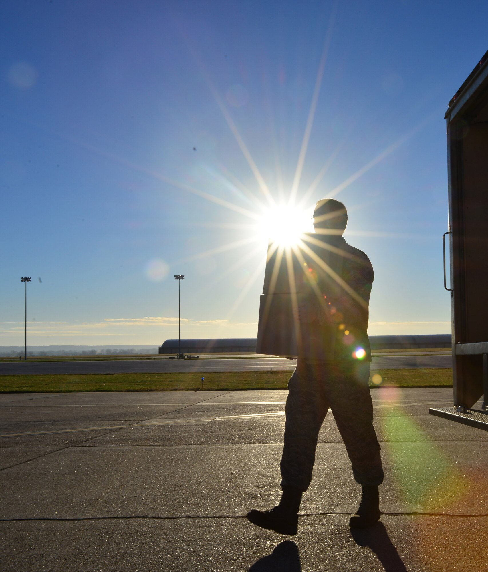 A member of Defense Courier Station Offutt transports boxes containing sensitive equipment on the flight line at Offutt Air Force Base, Neb., Nov. 16, 2016. Defense couriers move sensitive and top secret material globally for the Department of Defense and other government agencies. (U.S. Air Force photo/Senior Airman Rachel Hammes)