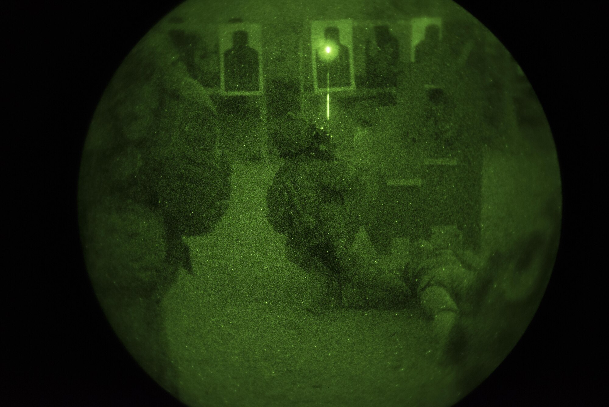 Senior Airman Andre, 83rd Expeditionary Rescue Squadron pararescueman, provides cover fire while treating a simulated casualty during night firing drills Nov. 18, 2016 at Bagram Airfield, Afghanistan. Pararescue teams assault and secure rescue objective areas in order to treat and extricate casualties during a combat rescue response. (U.S. Air Force photo by Staff Sgt. Katherine Spessa)
