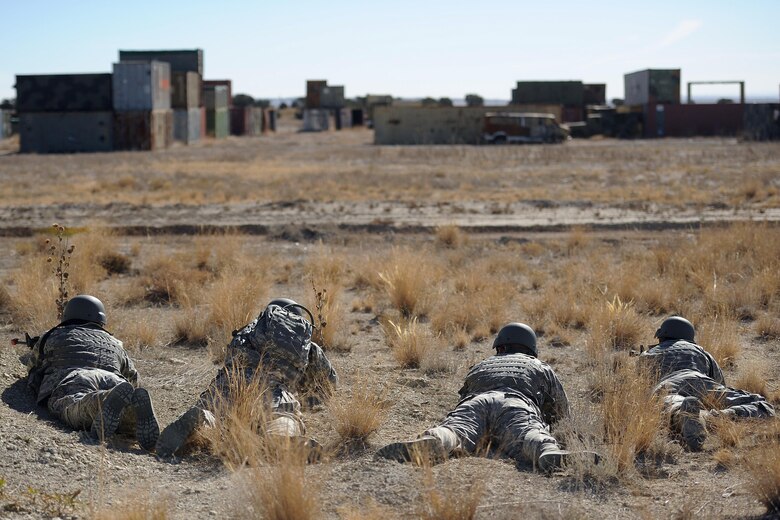 Members of the 3rd Space Operations Squadron lay in prone position, observing “enemy” territory as 13th Air Support Operations Squadron moves in to attack during a training exercise at Fort Carson, Colorado, Wednesday, Nov. 9, 2016. The end of the operation was in sight as the teams entered this territory. (U.S. Air Force photo/Dennis Rogers)