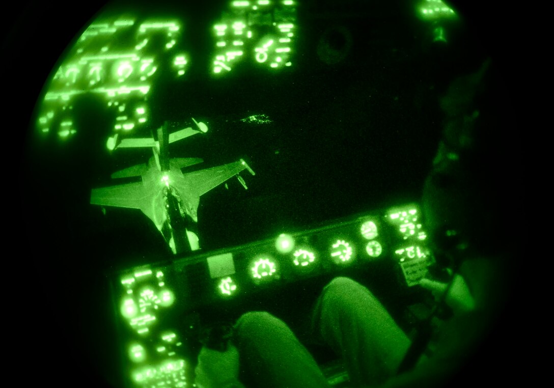 Tech. Sgt. Alan Greene, a 70th Air Refueling Squadron boom operator, lowers the boom to an F-16 Fighting Falcon during an aerial refueling mission out of Luke Air Force Base, Ariz., Nov. 16, 2016. F-16 pilots train on refueling operations to be prepared for longer mission requirements. (U.S. Air Force photo/Senior Airman James Hensley)