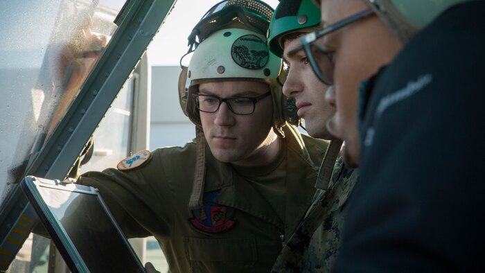 Sgt. Stephen Wilson and Cpl. Dennis Parker work with an Aircraft Survivability Equipment Readiness Team member to assess the onboard systems and tactical aircraft protection system on a UH-1Y Venom at Marine Corps Air Station New River, N.C., Nov. 17, 2016. Marine Medium Tilitrotor Squadron 365 (Reinforced) conducted the assessment to prepare for their upcoming deployment with the 24th Marine Expeditionary Unit. The Marines serve as aircraft avionics technicians with the unit. 