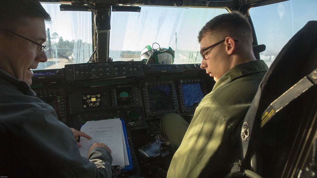 Jon Ayers discusses the cockpit armament controls in a V-22 Osprey with Lance Cpl. Jared Wooten while assessing the aircraft’s onboard systems and tactical aircraft protection system at Marine Corps Air Station New River, N.C., Nov. 17, 2016. Marine Medium Tilitrotor Squadron 365 (Reinforced) underwent the assessment to prepare for their upcoming deployment with the 24th Marine Expeditionary Unit. Ayers is a ALE -47 program Navy Logistician with the fleet support team. Wooten serves as a V-22 Osprey avionics technician with the unit. 