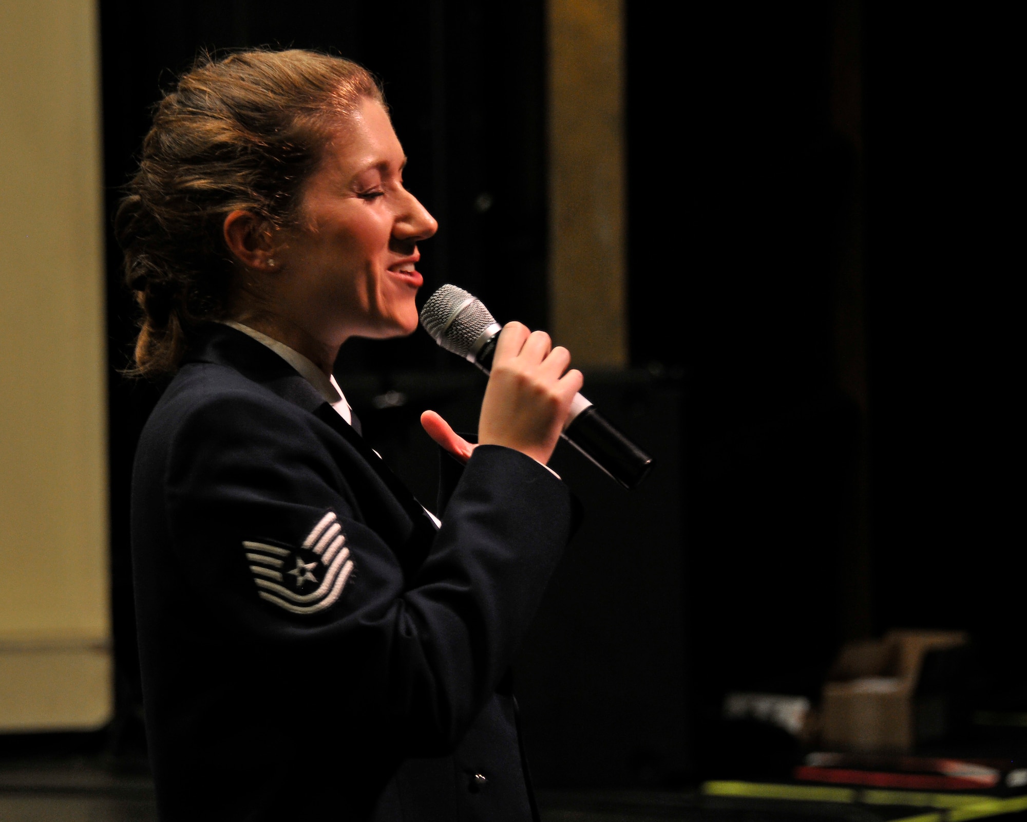 U.S. Air Force Tech. Sgt. Carrie L. Gatz, an instrumentalist with the 566th Air Force Band, sings "Shake It Off" at the Illinois Music Educators Association conference opening night in Peoria, Ill., Jan. 28, 2015. The 566th AFB serves in war and peace by preserving national heritage through the power of music at military, recruiting and community relations events. (U.S. Air National Guard photo by Staff Sgt. Lealan Buehrer)