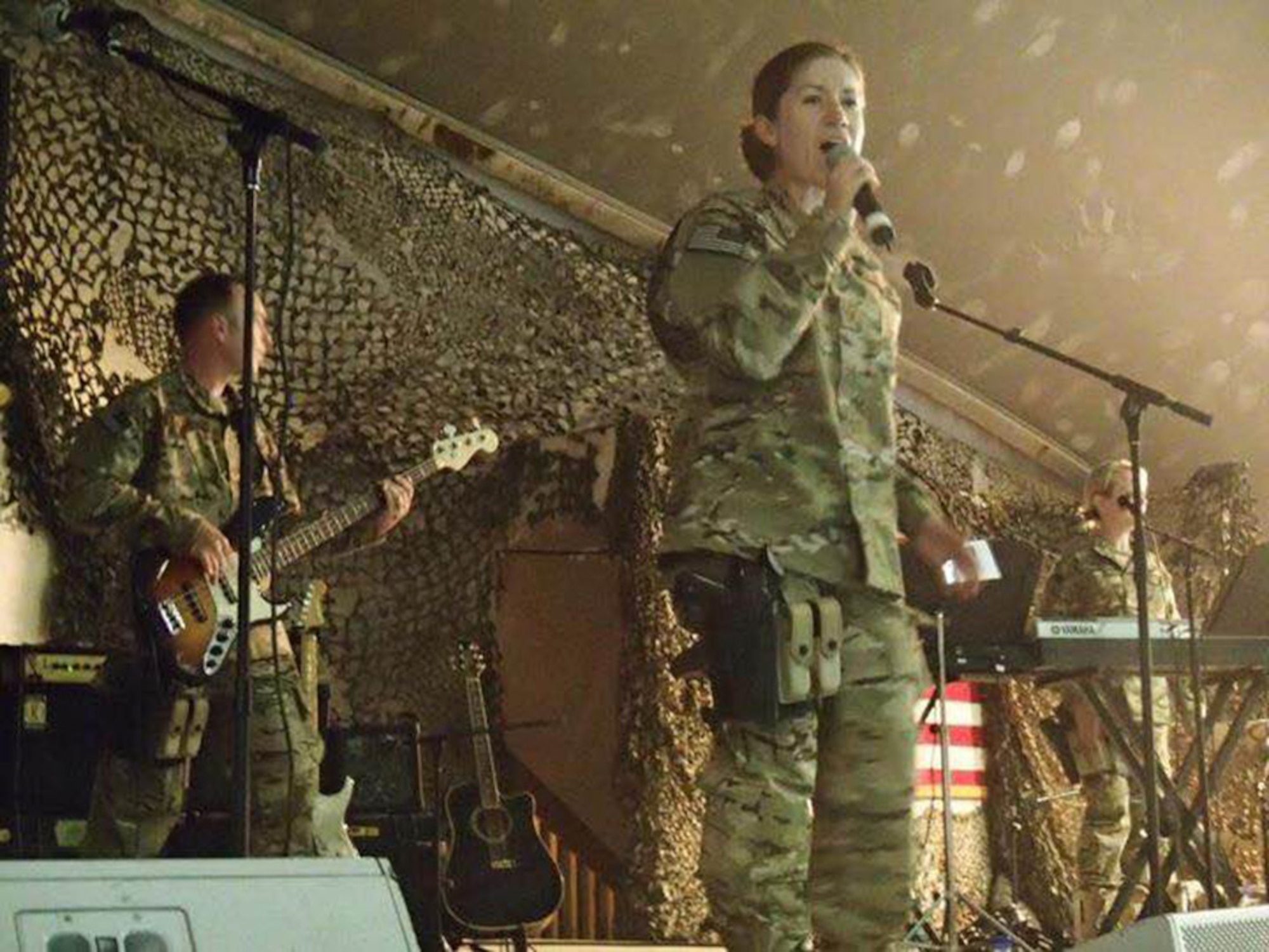U.S. Air Force Tech. Sgt. Carrie Gatz, an instrumentalist with the 566th Air Force Band, Illinois Air National Guard, sings during a performance at an undisclosed location in Southwest Asia in 2012. Gatz was deployed in support of Operation Enduring Freedom. (Courtesy photo)