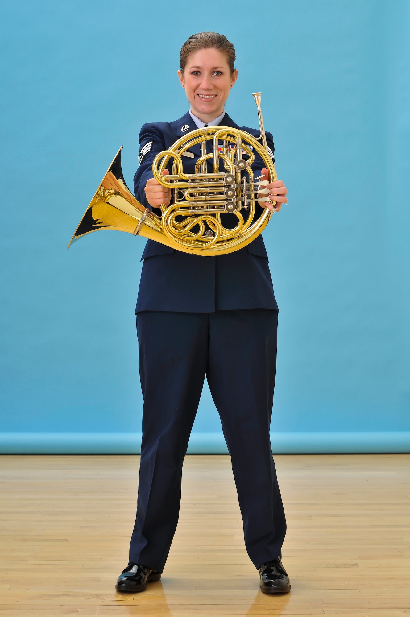 U.S. Air Force Staff Sgt. Carrie Gatz, an instrumentalist with the 566th Air Force Band, Illinois Air National Guard, poses with her French horn at the 182nd Airlift Wing in Peoria, Ill., Feb. 5, 2012. Gatz has served with the unit since 2004. (U.S. Air National Guard photo by Master Sgt. Scott Thompson)
