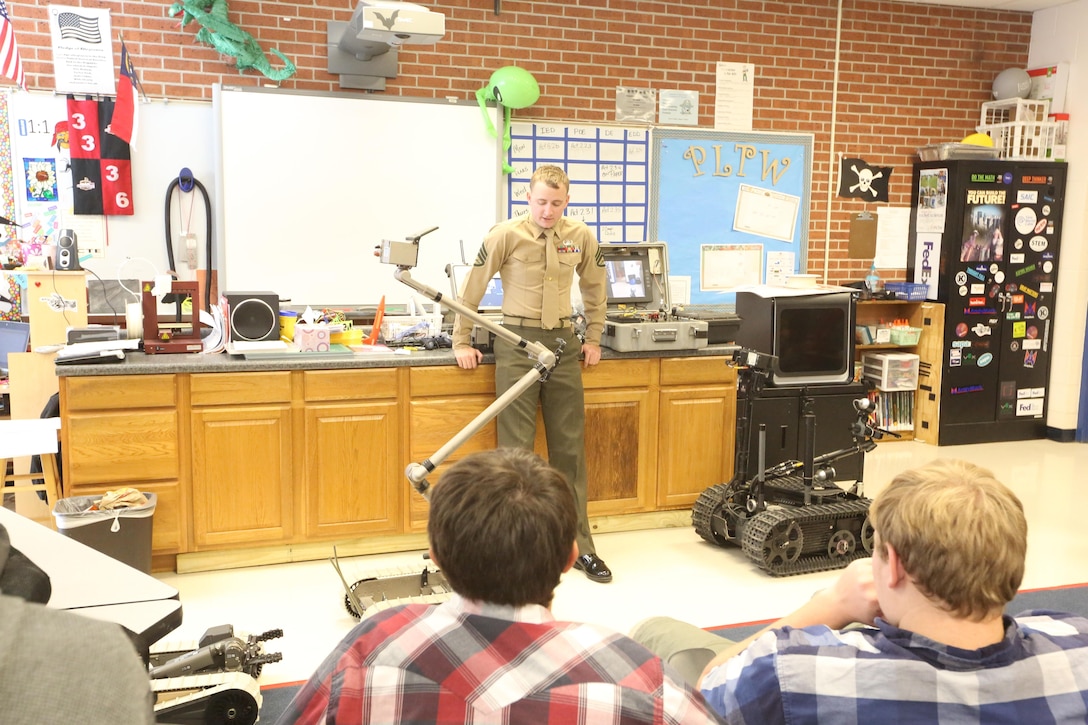 Staff Sgt. Daniel L. Lohmann teaches a class about the robots that Marines use during a robotics demonstration at Swansboro High School in Swansboro, N.C., Nov. 17, 2016. Explosive ordnance disposal technician Marines gave demonstrations to the Swansboro High School Robotics Team to give them ideas for their upcoming competition while strengthening the community relationship. Lohmann is a team leader with Explosive Ordnance Disposal Company, 2nd Marine Logistics Group, at Camp Lejeune, N.C. (U.S. Marine Corps photo by Sgt. Clemente C. Garcia)