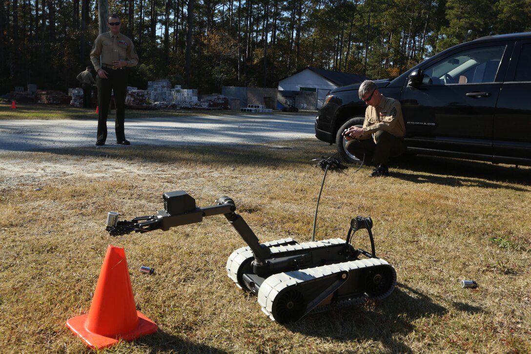 Staff Sgt. Steven M. Smith demonstrates some of capabilities of the 310 SUGV System robot by placing a battery in a cone while at the Swansboro High School in Swansboro, N.C., Nov. 17, 2016. The Marines came to help the school’s robotics team by teaching them the basics and giving them a foundation in robotics. Smith is a team leader with Explosive Ordnance Disposal Company, 2nd Marine Logistics Group, at Camp Lejeune, N.C. (U.S. Marine Corps photo by Sgt. Clemente C. Garcia)