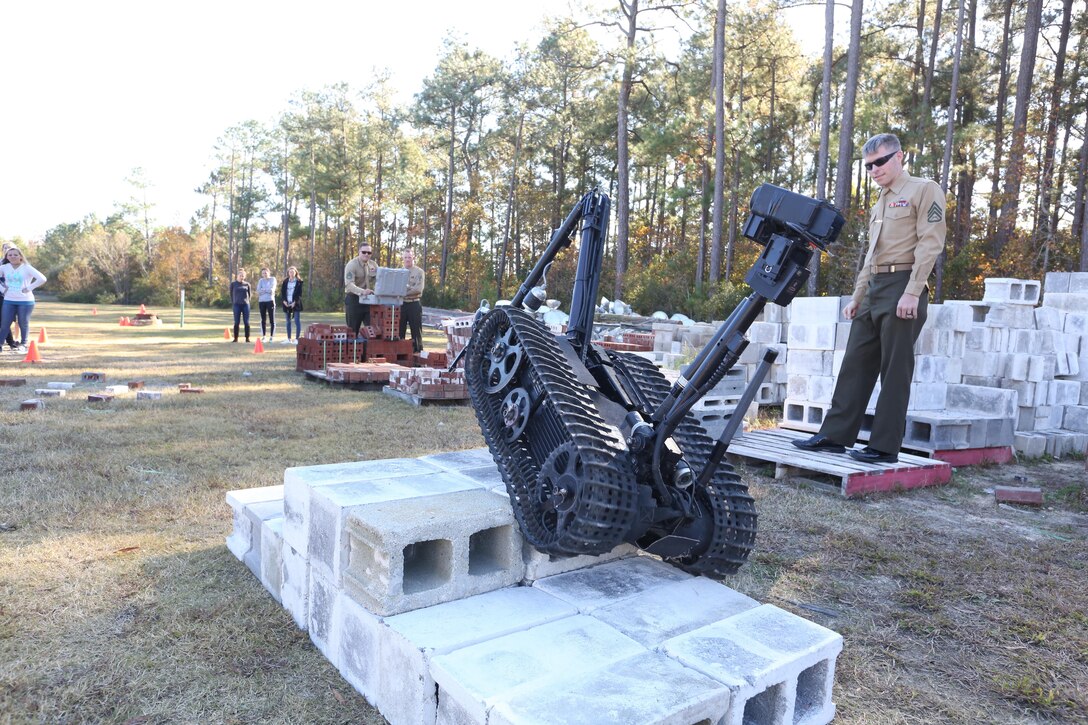 Staff Sgt. Justin S. Bryant shows a high school robotics team that the MK-2 Talon Robot can climb over objects during a demonstration at Swansboro High School in Swansboro, N.C., Nov. 17, 2016. The Marines have been coming to the school for the past three years to help inspire the student’s creativity. The Marines are explosive ordnance disposal technicians with Explosive Ordnance Disposal Company, 2nd Marine Logistics Group. (U.S. Marine Corps photo by Sgt. Clemente C. Garcia)