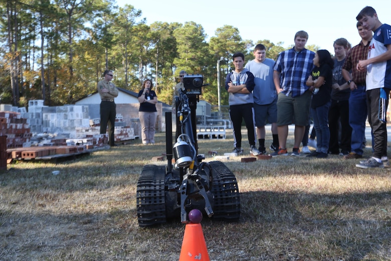 Marines remote control an MK-2 Talon robot during a demonstration for the Swansboro High School Robotics Team in Swansboro, N.C., Nov. 17, 2016. The Marines displayed three of their robots to students during a community relation event to inspire the students’ creativity through robotics. The Marines are explosive ordnance disposal technicians with Explosive Ordnance Disposal Company, 2nd Marine Logistics Group. (U.S. Marine Corps photo by Sgt. Clemente C. Garcia)