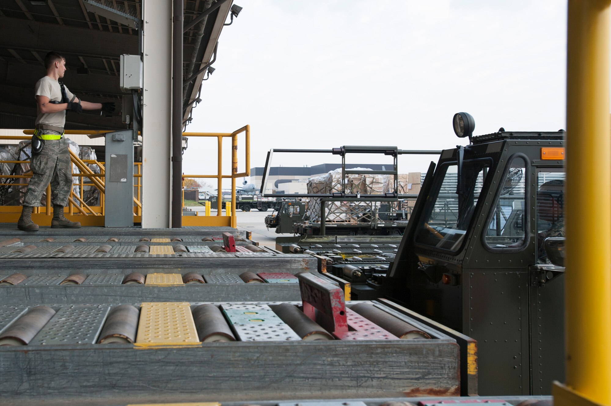A member of the 305th Aerial Port Squadron prepares to unload cargo from a Tunner 60K Aircraft Loader Nov. 16 at Joint Base McGuire-Dix Lakehurst, N.J. Engineers with DRS Technologies, along with AMC and 305 APS personnel conducted initial testing of a prototype rail extension system on the Tunner 60K Aircraft Loader here. The rail system is designed to extend during cargo loading and unloading to mitigate personnel fall risk. 