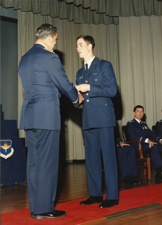 U.S. Air Force 2nd Lt. John Marks, now a Lt. Col., shakes hands with an Air Force official during his graduation from Officer Training School in 1987. Marks attended undergraduate pilot training at Columbus Air Force Base, Mississippi, shortly after his OTS graduation. (Courtesy photo provided by Mary Marks)