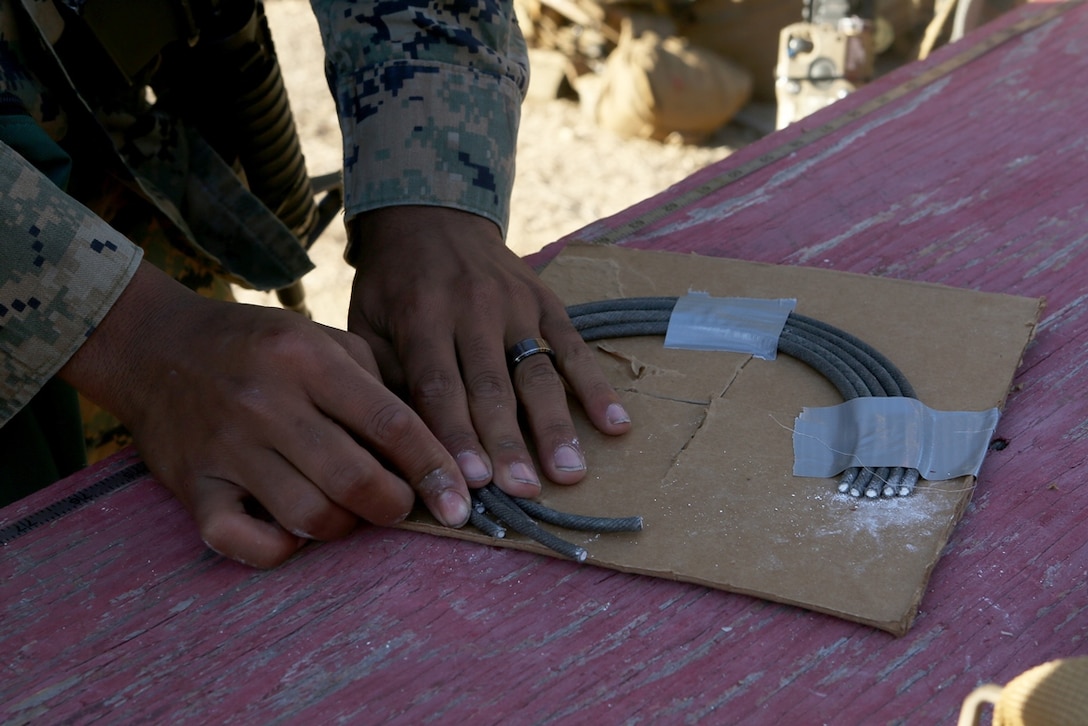 U.S. Marines with the Bravo Company, 7th Engineer Support Battalion, 1st Marine Logistics Group, build a door hinge bomb charge, designed to blow a hole around a door hinge for quick entry during urban breaching exercises at Camp Pendleton, Calif., Nov. 17, 2016. The Marines with 7th ESB were put into fire teams and tasked to build explosive devices such as a hinge charge, water charge and body charge to forcefully open a locked door. (U.S. Marine Corps photo by Lance Cpl. Joseph Sorci)