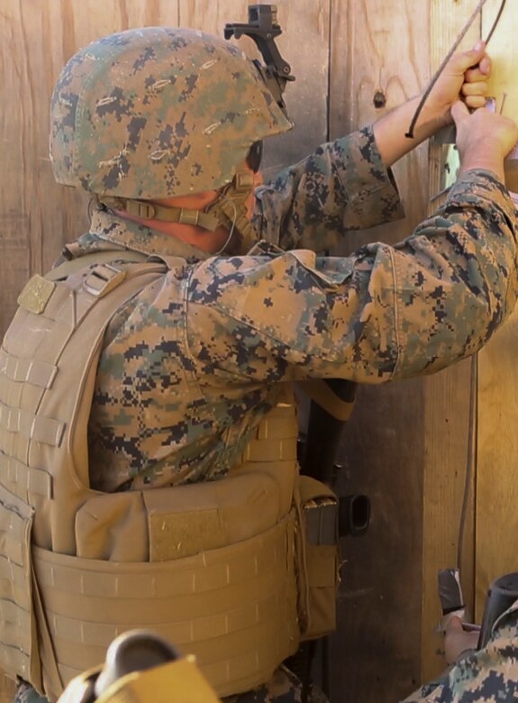 U.S. Marine Lance Cpl. Ryan Malley sets up a hinge charge in preparation for urban breaching training at Camp Pendleton, Calif., Nov. 17, 2016. The hinge charge is a small explosive designed to detonate a door hinge for easy entry to a building. Malley is a combat engineer with Bravo Company, 7th Engineer Support Battalion, 1st Marine Logistics Group. The Marines with 7th ESB were put into fire teams and tasked to build explosive devices such as a hinge charges, water charges and body charges to forcefully open a locked door. (U.S. Marine Corps Photo by Lance Cpl. Joseph Sorci)